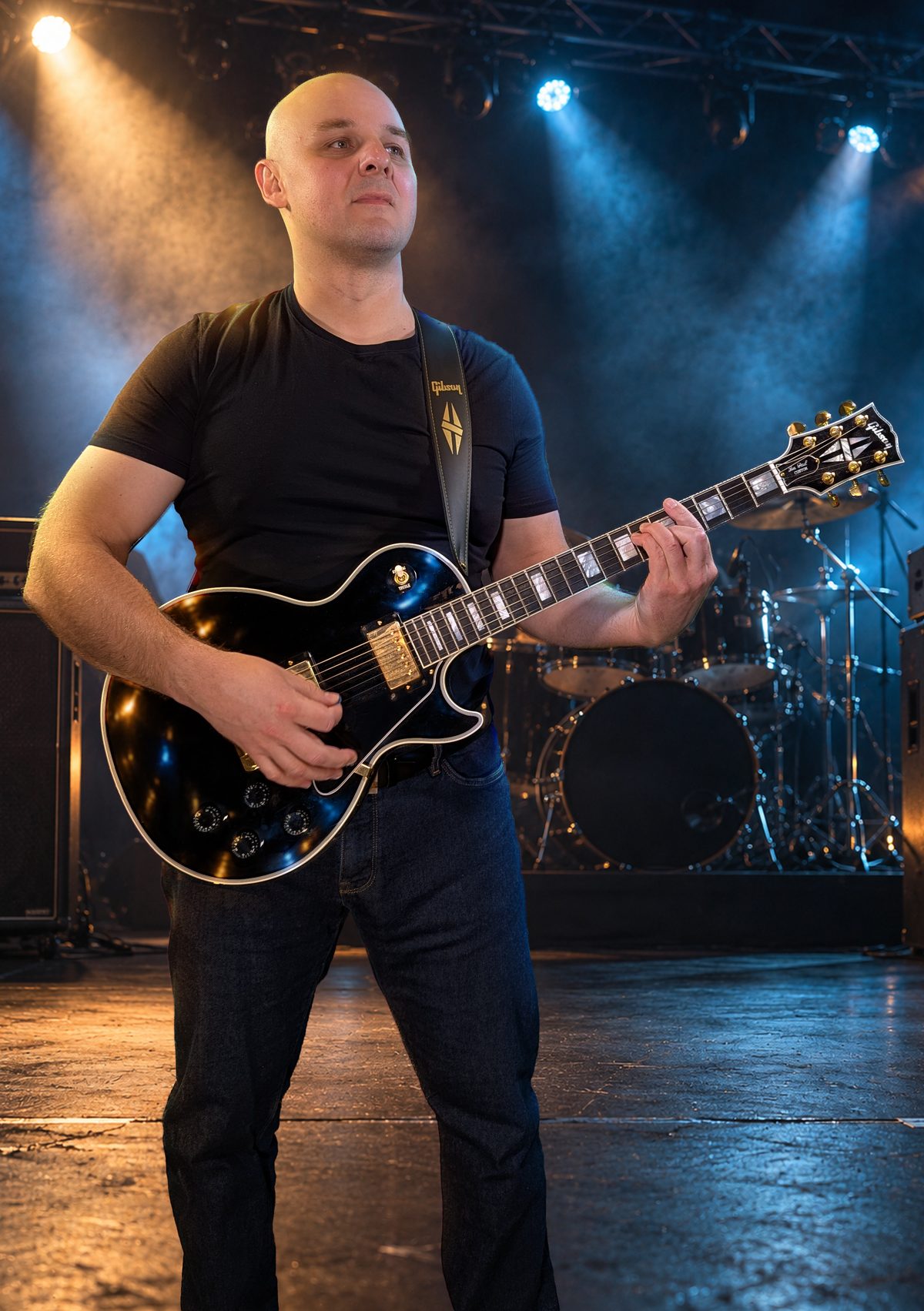 Vykintas on stage playing a Gibson Les Paul Custom guitar